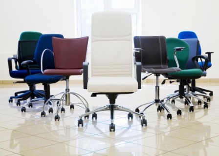 photo of multi-colored office chairs arranged in a line