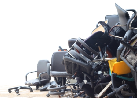 a large pile of various broken office chairs