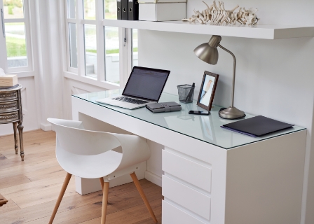 a home office setup with modern white pieces