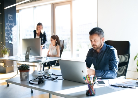 3 people collaborating in an open office space