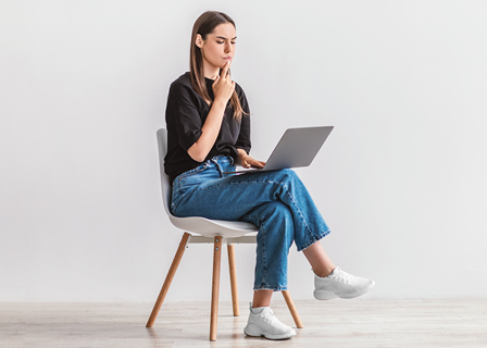 woman sitting in chair online shopping