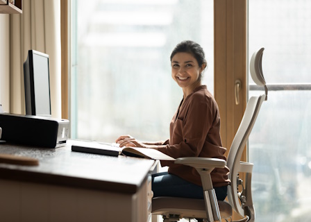 woman sitting with good posture at a desk