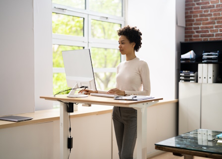 woman working at adjustable standing desk 