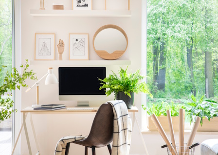 man inspecting desk home office area by window