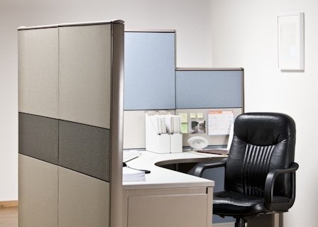 man inspecting desk office chair in cubicle