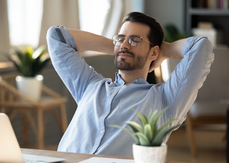 man resting in office chair with eyes closed