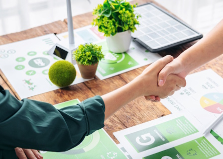 shaking hands over desk