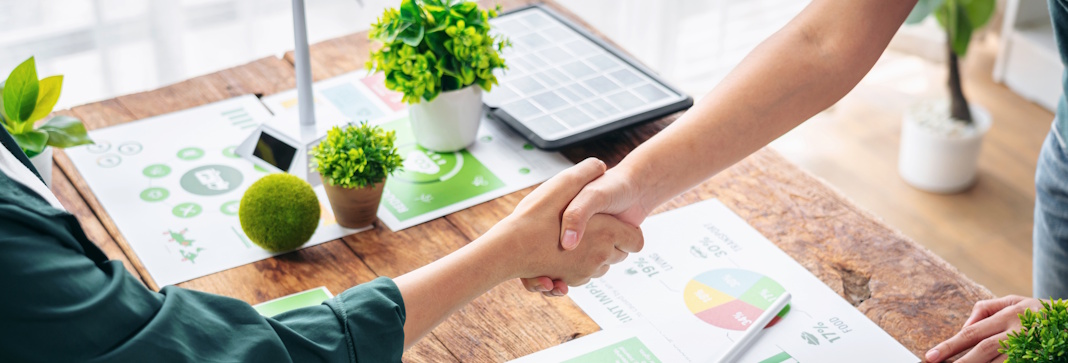 shaking hands over desk