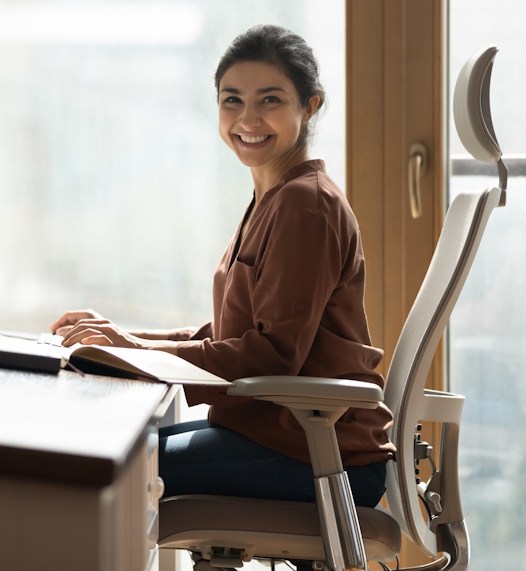 happy woman sitting in comfortable office chair