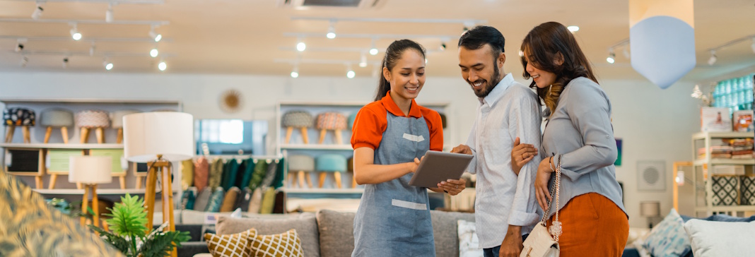 couple looking at furniture with salesperson